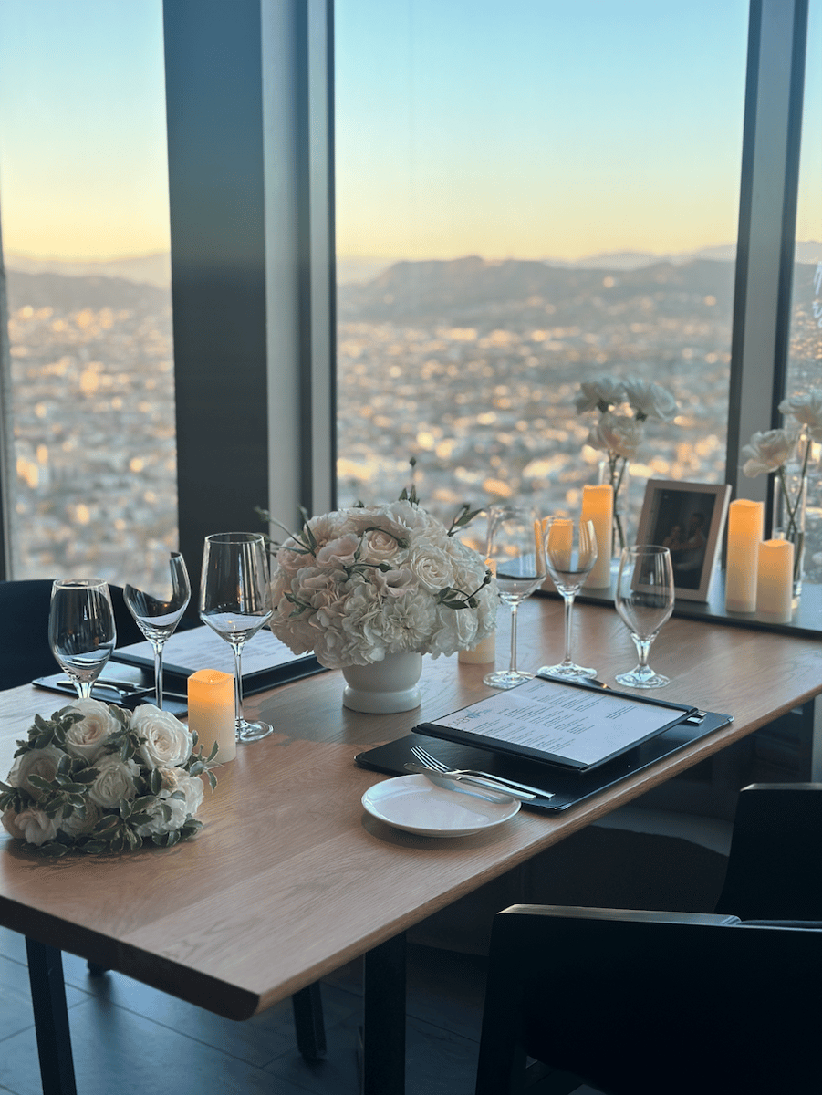 Private dining room at 71Above with panoramic views of Downtown Los Angeles and elegant table settings.