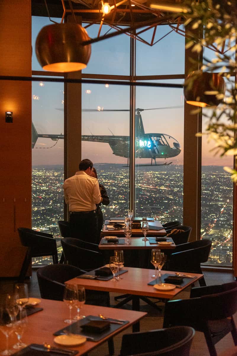 Guest taking in the sweeping panoramic view of Los Angeles from 71Above restaurant, 1000 feet above Downtown LA
