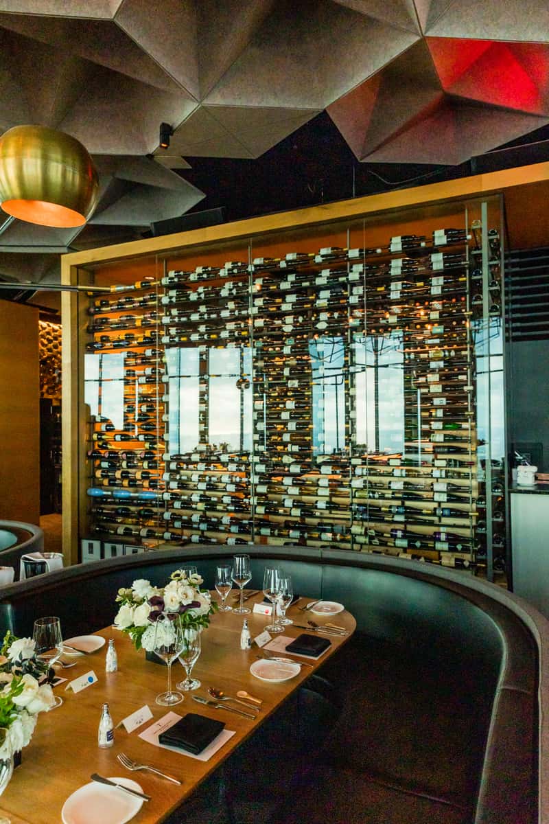 Curated wine pairings at 71Above with glasses set against the twinkling Los Angeles skyline.
