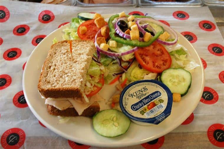 half of sandwich and a salad on a plate