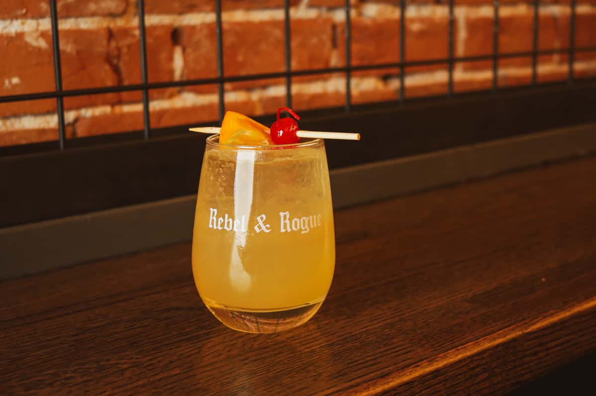 Cocktail in a glass with the Rebel & Rogue logo