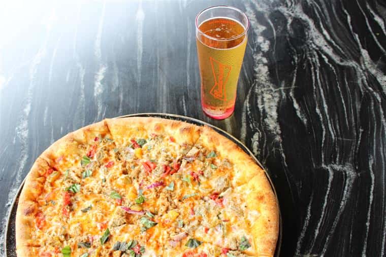 pizza with a glass of beer on table top