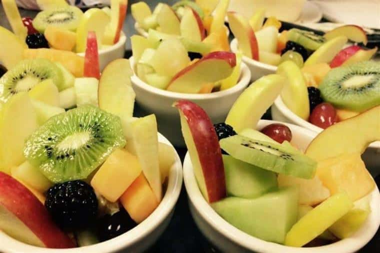 fruit cups with cantaloupe, pineapple, apples, honeydew melon, blackberries, grapes and kiwi