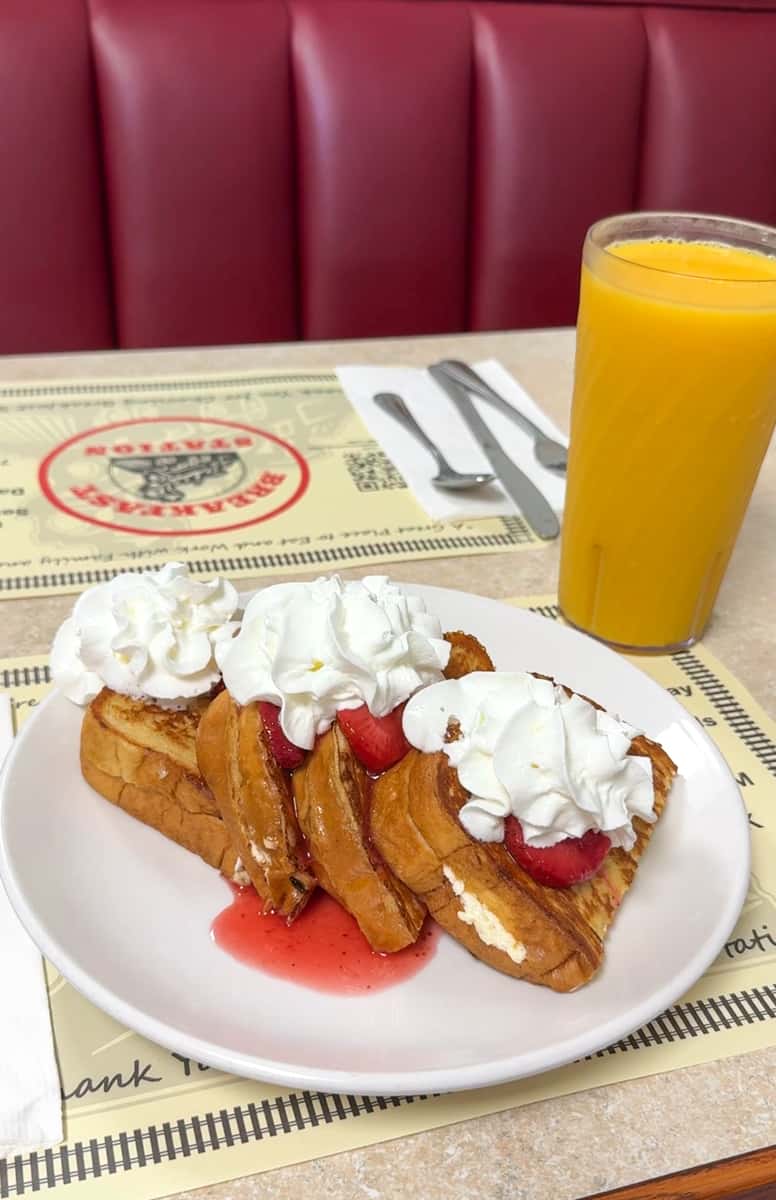french toast with strawberry topping and whipped cream