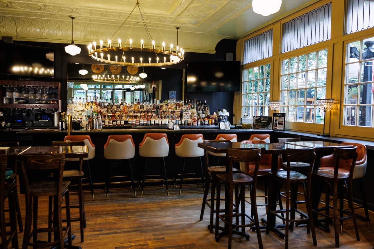 Warm and inviting dining room with a full-service bar at Serafini Italian fusion restaurant in historic downtown Frankfort, Kentucky.