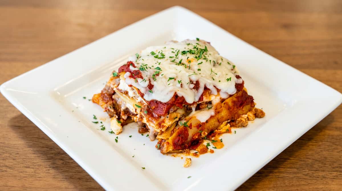 Homemade beef lasagna topped with melted mozzarella, served at Serafini, an Italian fusion restaurant in historic downtown Frankfort, Kentucky.