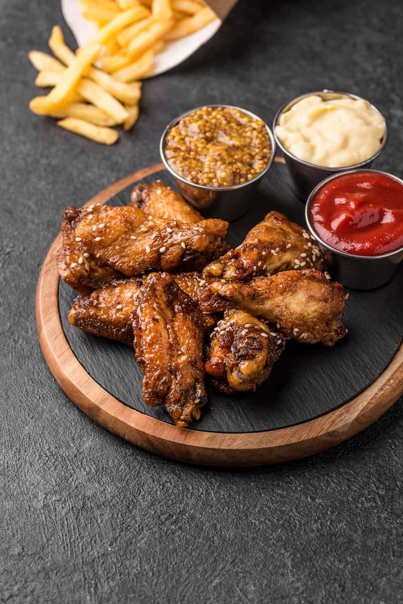 Chicken wings served with sauces