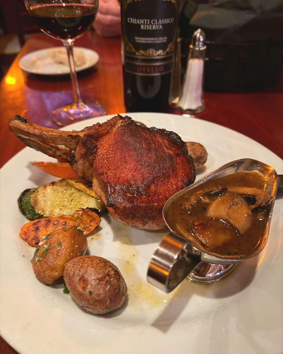 Italian roasted meat entrée with vegetables and rich brown sauce at Positano Ristorante Italiano