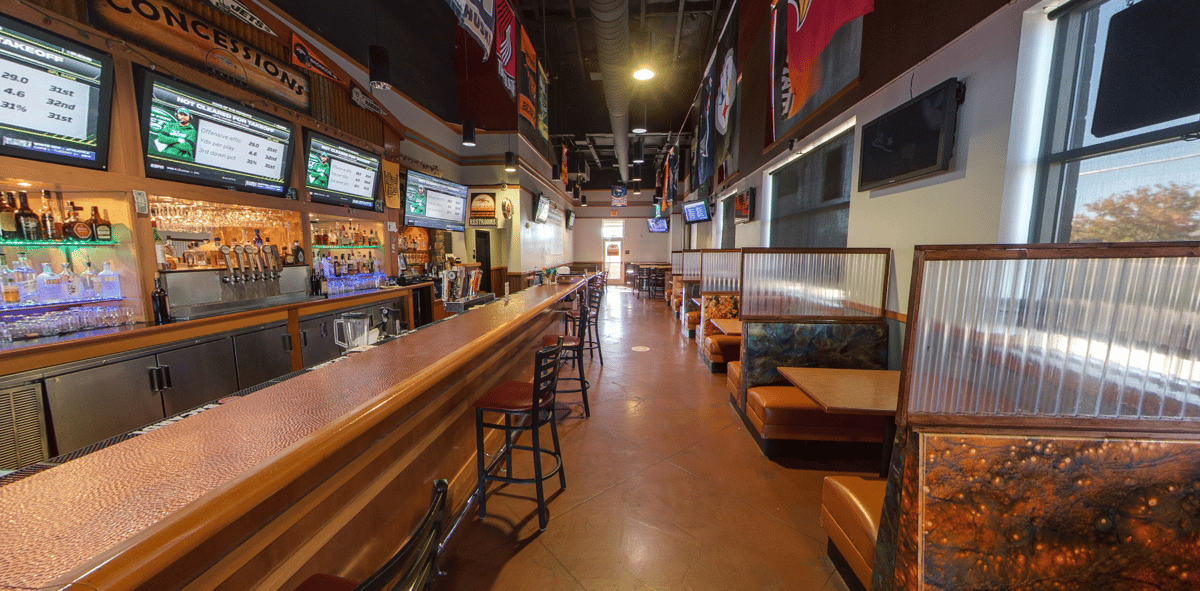 main bar area with tv screens, bar, and booths