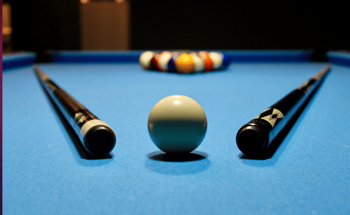 Pool Table with sticks and pool balls