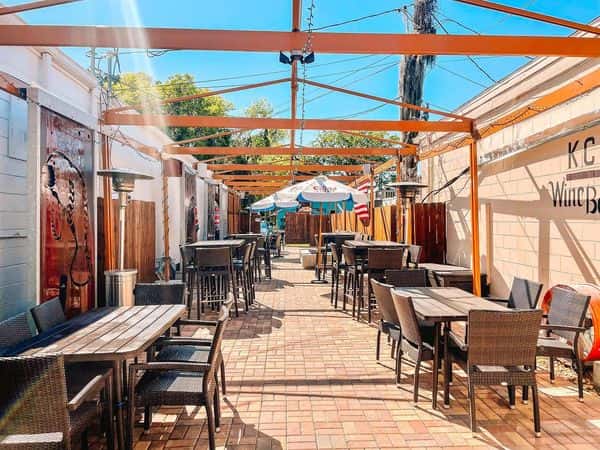 Outdoor wine bistro patio with pergola and empty tables