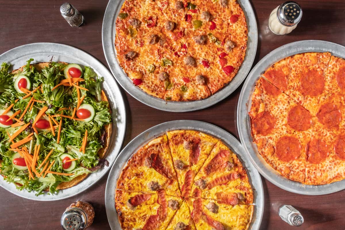 spread of 4 varieties of pizza