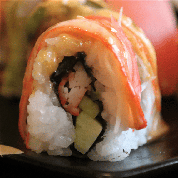 sushi roll filled and stuffed with crab meat and cucumbers