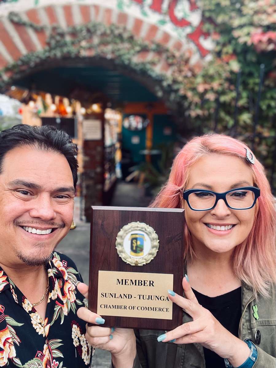 Jose Grijalva and Tumara Arnett, owners, holding a chamber of commerce plaque
