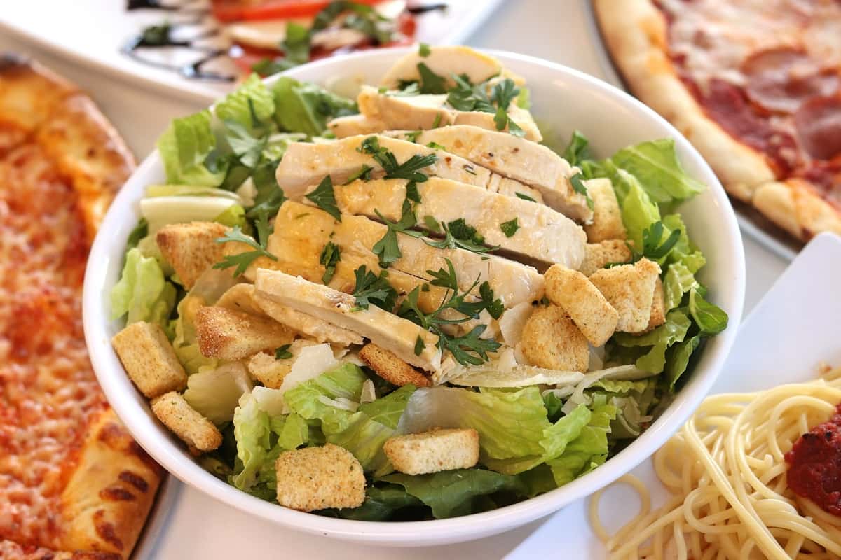 Caesar salad with sliced chicken