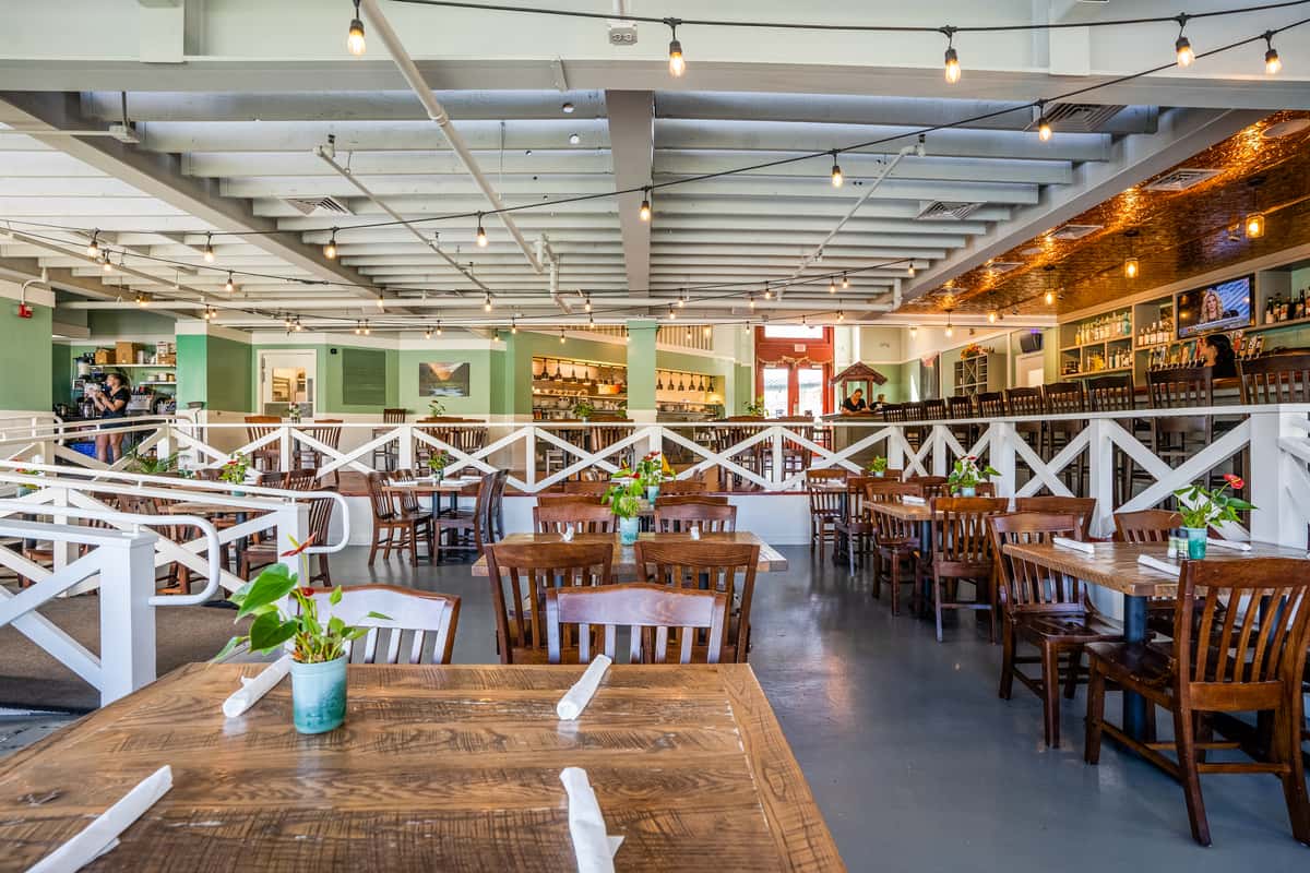 Dining room at Waikoloa Fosters with oak tables and chairs.