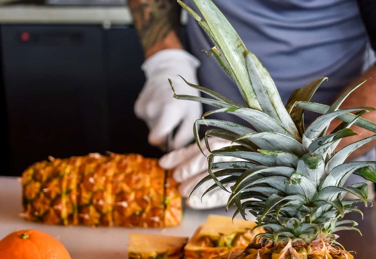 Chef slicing pineapple