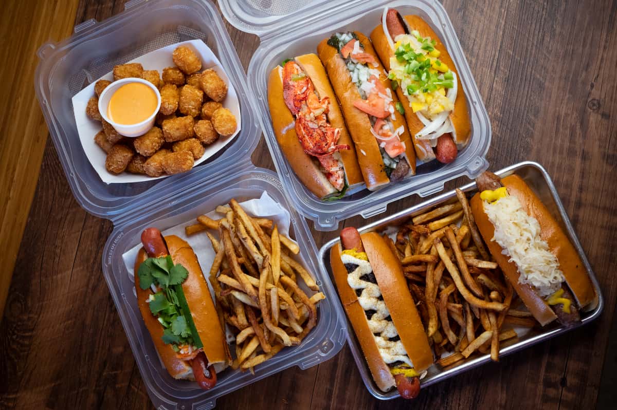 Hot dogs, fries, and tater tots in to go containers