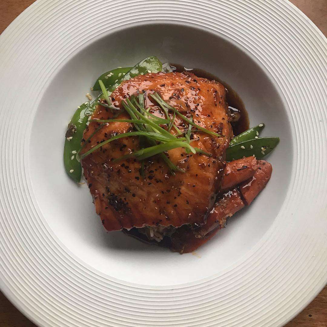 Salmon glazed with a teriyaki ponzu sauce, with scallion jasmine rice, and marinated snap and snow peas
