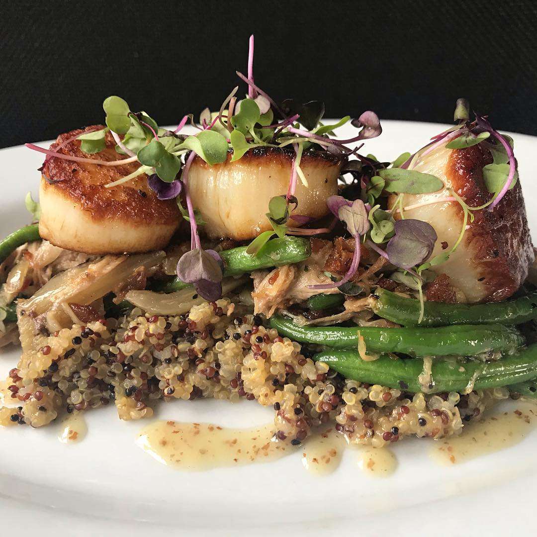 seared scallops with suckling pig on a bed of quinoa with sous vide fennel, green beans, and a creole mustard vinaigrette
