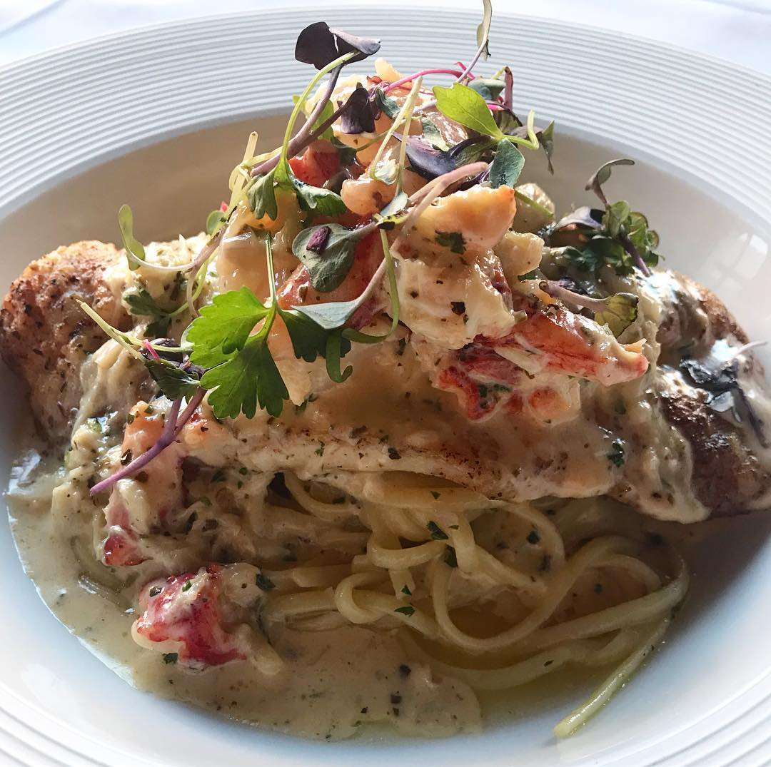 Sheepshead topped with shrimp, crab, and lobster in a lemon butter sauce on fettuccine