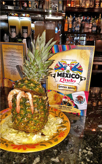 pineapple with shrimp coming out of it