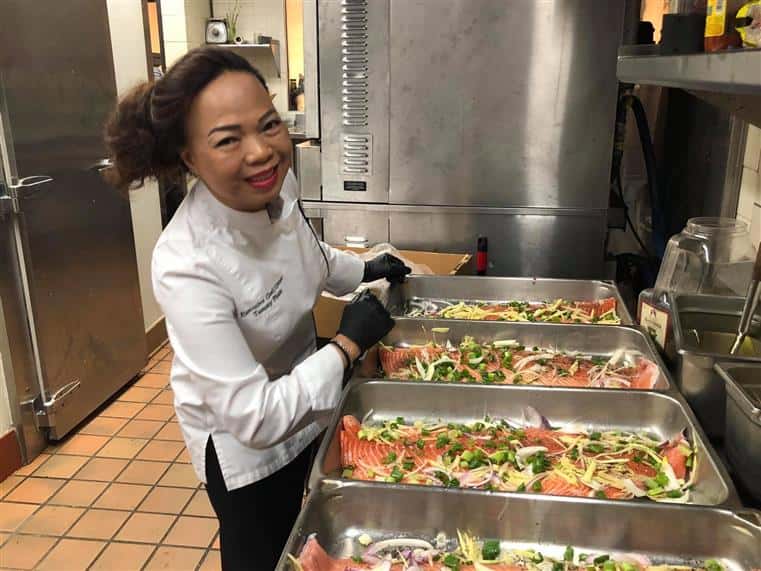 Chef smiling and cooking in the kitchen