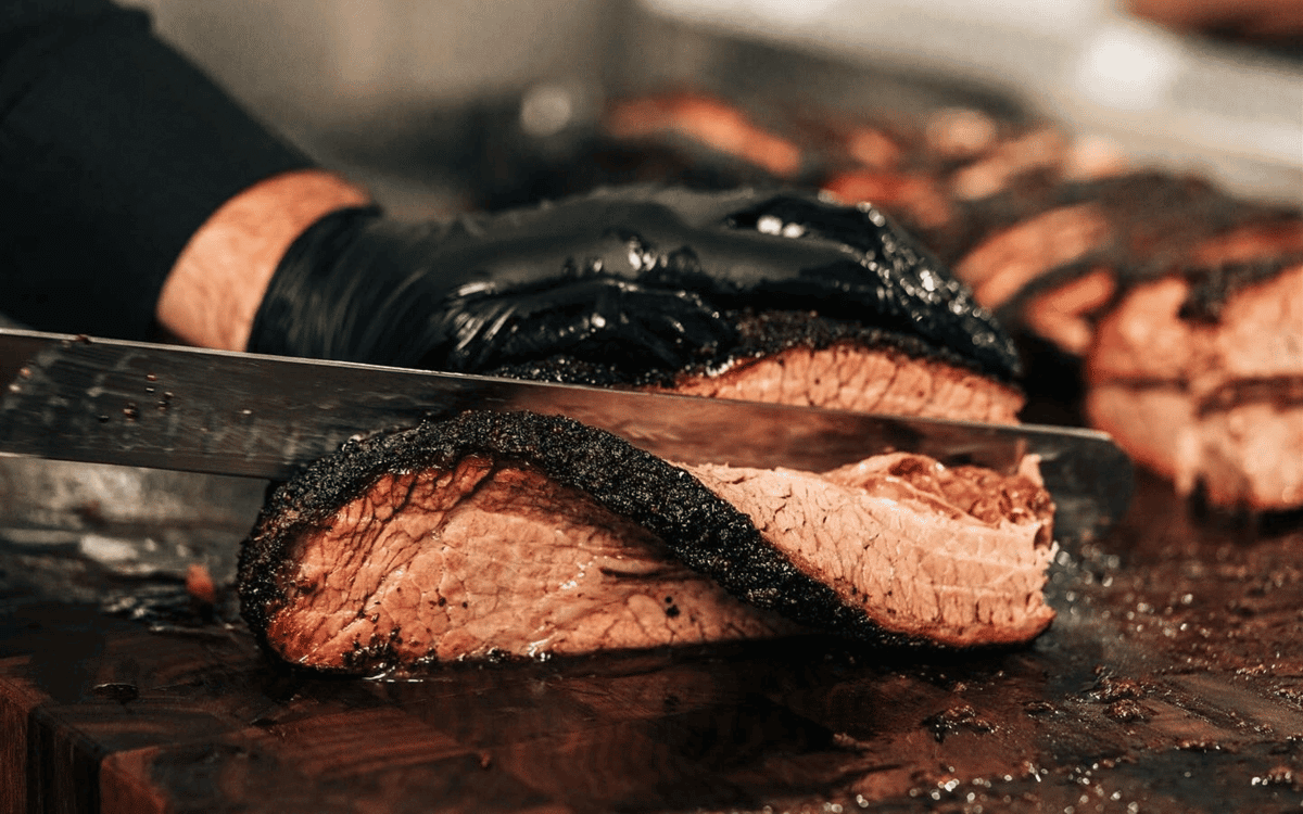 staff member slicing brisket