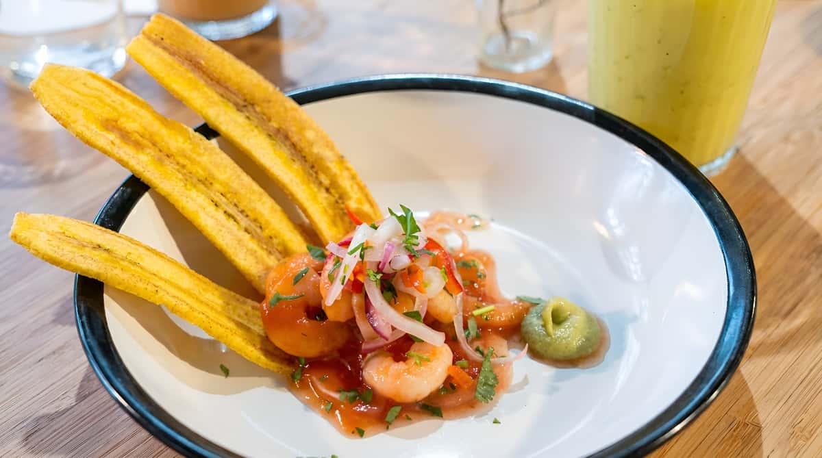 Shrimp ceviche served with sliced jalapeño and tostadas on the side