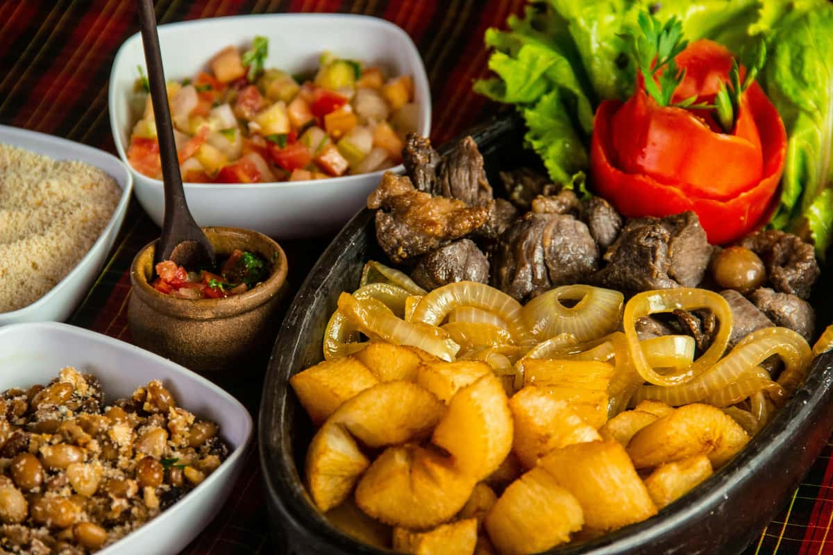 various dishes including meat, onion and sides