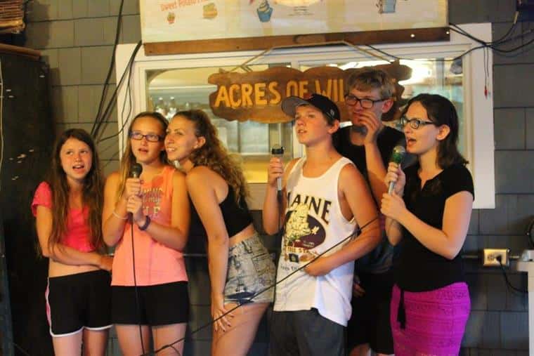 group of young kids performing karaoke