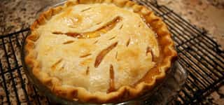 full apple pie on cooling rock