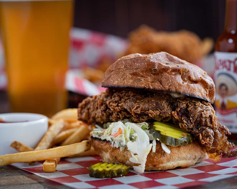 chicken sandwich with fries and a beer