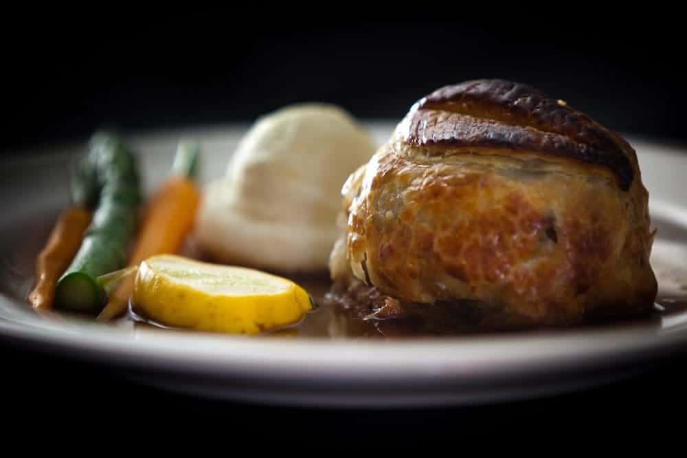 beef wellington plated with vegetables