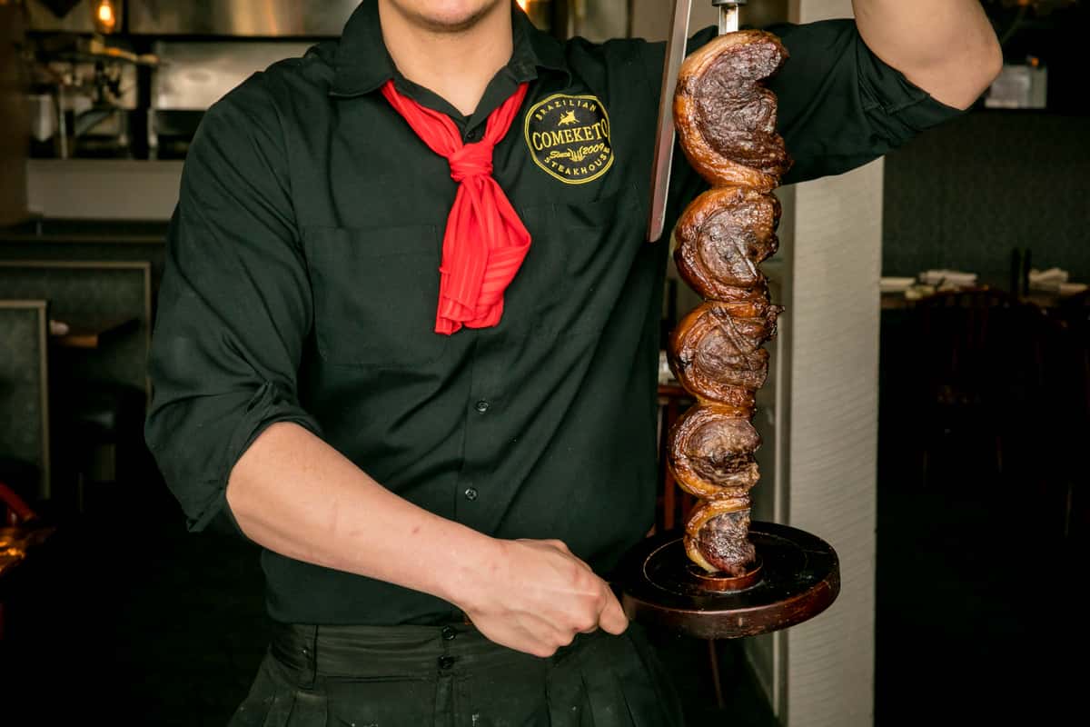 gauchos holding meat skewers