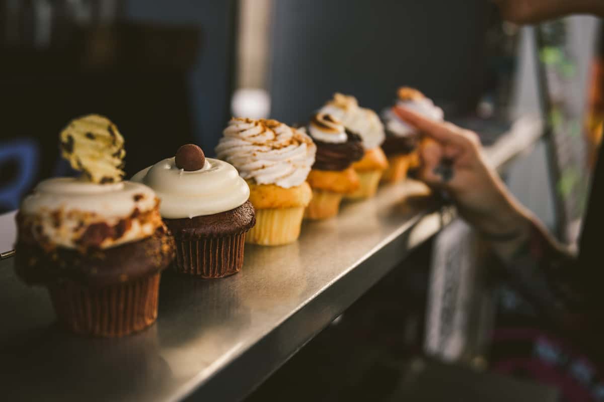person picking cupcake