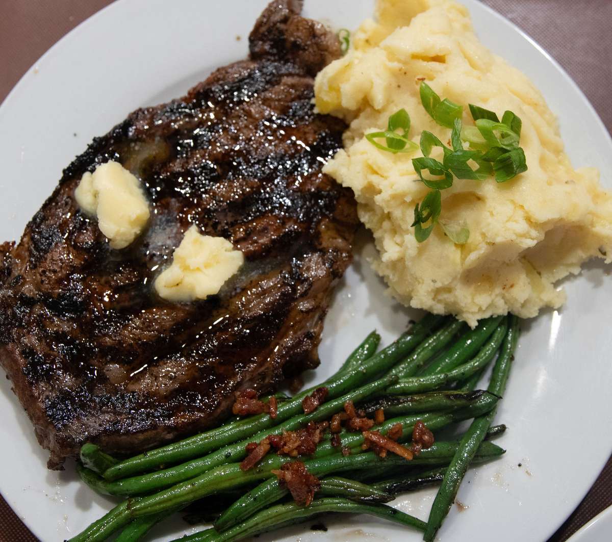 Steak night plate with ribeye, mashed potatoes, green beans