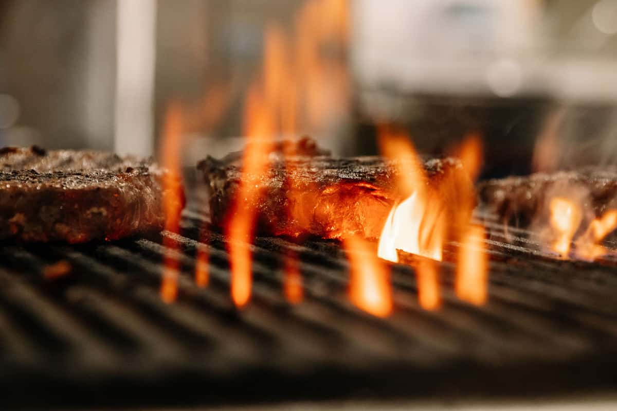 Fire grill cooking steaks