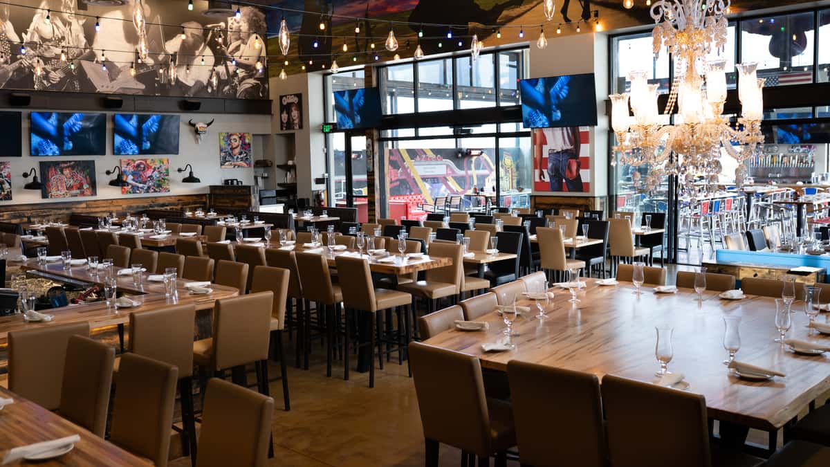 Image shows the indoor dining space at Rock & Brews with a wide variety of seating options like High Top Tables, Low Top Tables, and Booths.