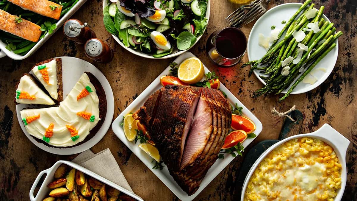 Easter dinner table with ham, asparagus and carrot cake