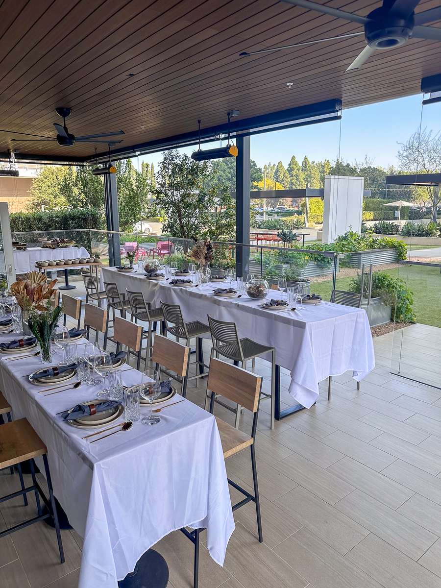 Catering set up at the MET in Costa Mesa with white table cloths in the garden
