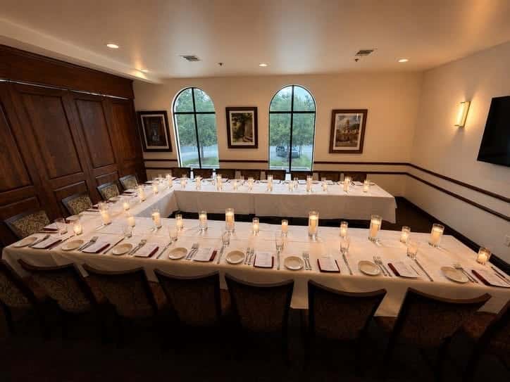 Dining tables setup in a U-shape for a private event