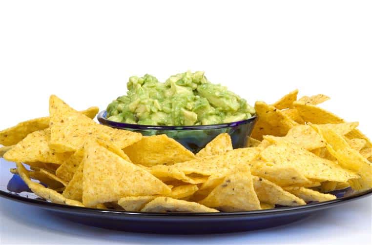 bowl of guacamole with chips for dipping