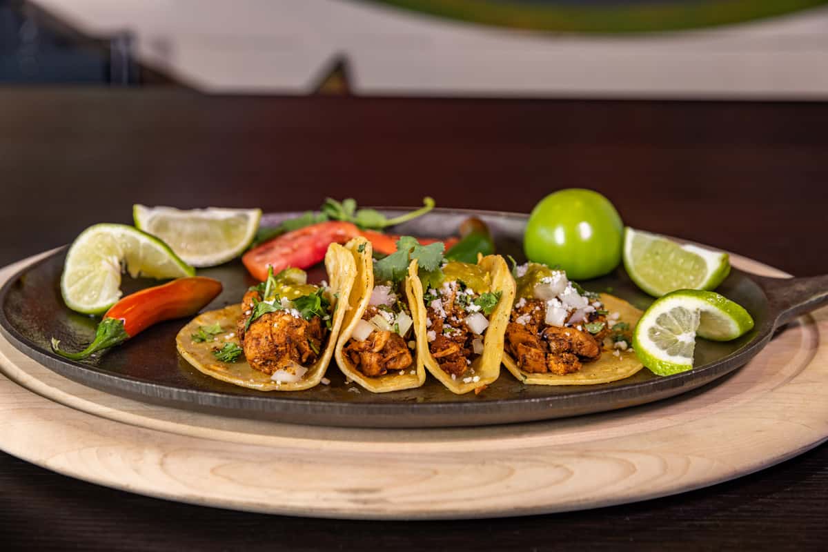 4 white corn tortillas with chipotle marinated chicken, onion, cilantro, Renegade HOT sauce and cotija cheese.