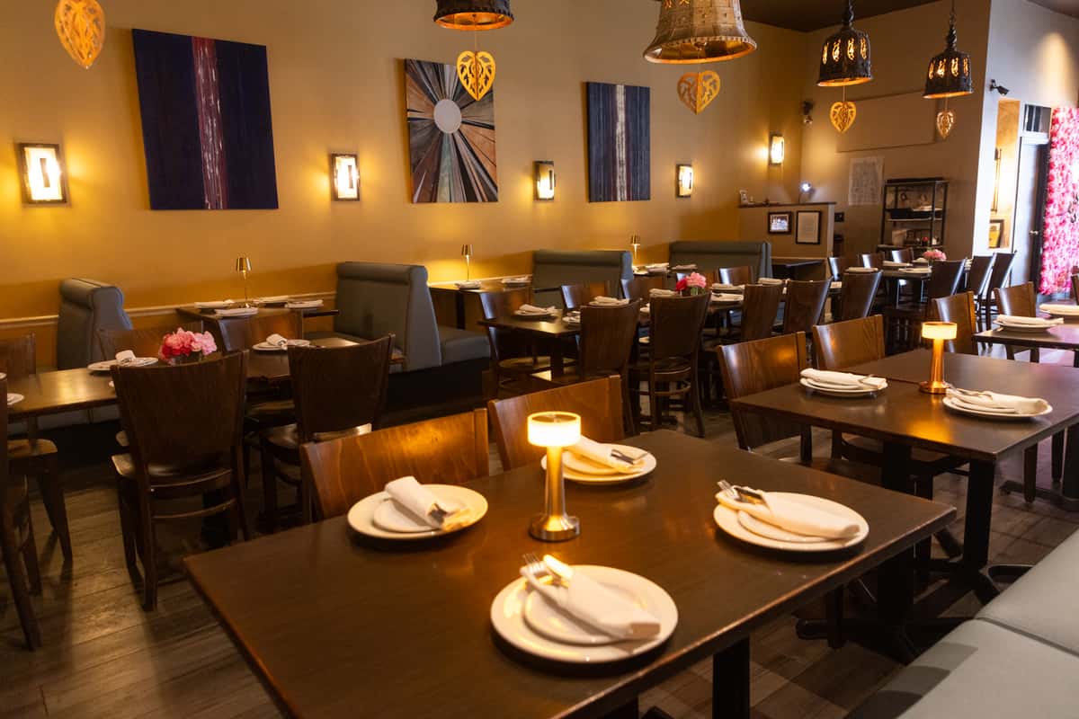 Warm ambient lighting, elegant table settings, and modern Thai-inspired décor create a cozy and inviting dining atmosphere perfect for casual dinners, celebrations, and intimate gatherings.