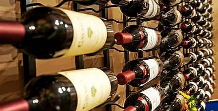 restaurant wine wall display with neatly arranged bottles on racks, showcasing curated wine selection and upscale dining ambiance