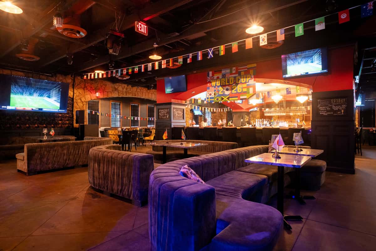 Dark and atmospheric interior of Sivas Tavern lounge with ambient lighting and seating