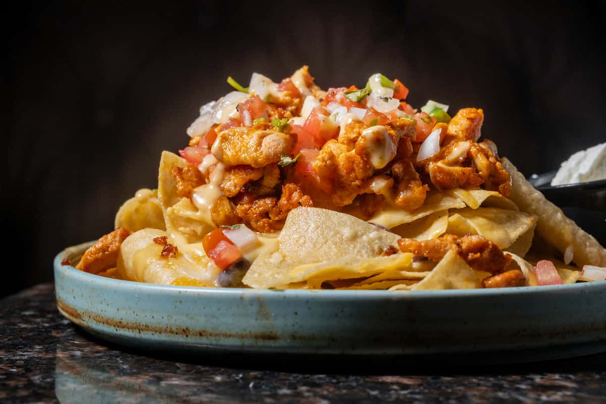 Loaded nachos with chips, seasoned meat, cheese, and fresh toppings served at Sivas Tavern