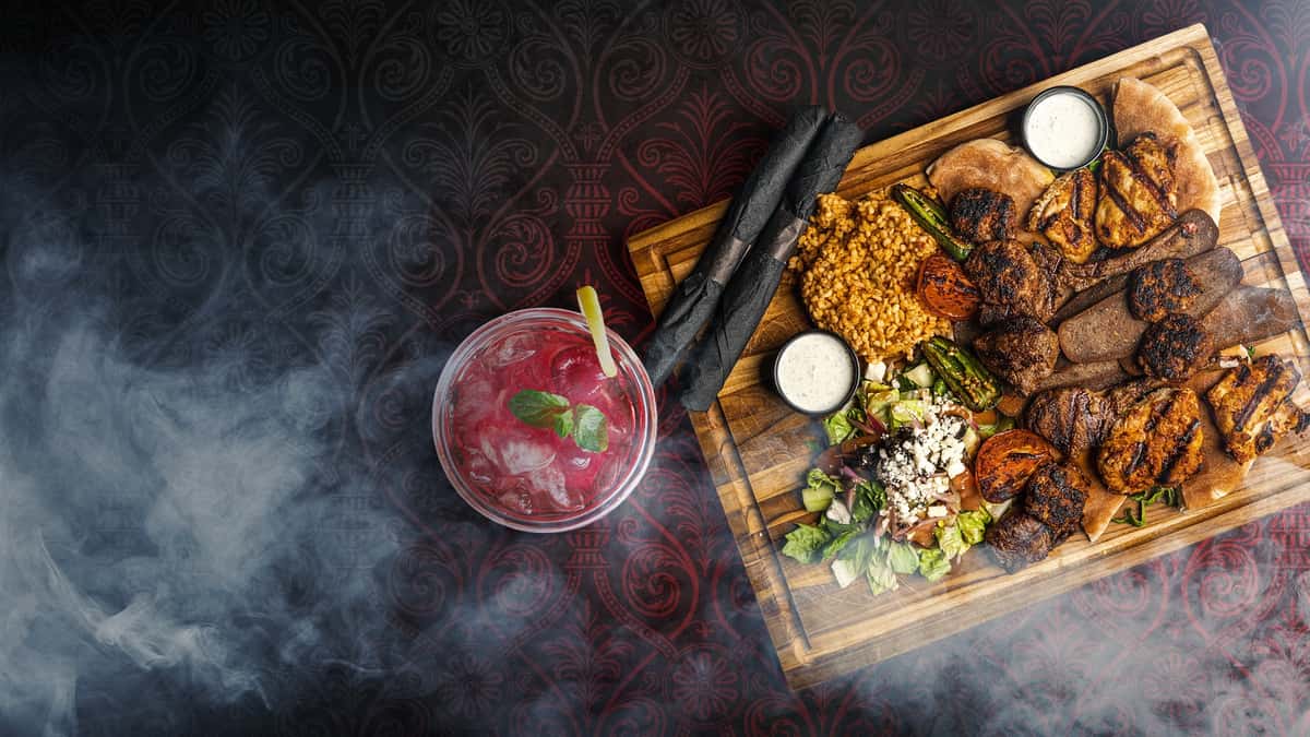 Cocktail and seafood platter at Sivas Tavern featuring upscale dining presentation and Southern-inspired cuisine