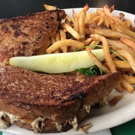 tuna melt sandwich with fries and a pickle
